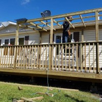 Doucette-Exteriors-White-Court-Alberta-Deck-Contractors-in-the-yard-with-fence