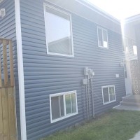 Doucette-Exteriors-White-Court-Alberta-Navy-Siding-project-from-the-side-view