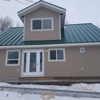 Doucette-Exteriors-White-Court-Alberta-beautiful-beige-siding-with-metal-roofing